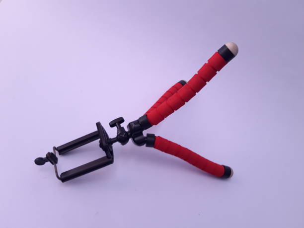 Mini portable tripod for phone photography laying on white background